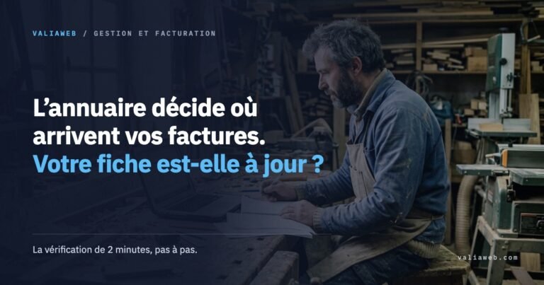 Un menuisier vérifie ses factures sur son ordinateur portable dans son atelier : l’annuaire décide où arrivent les factures électroniques